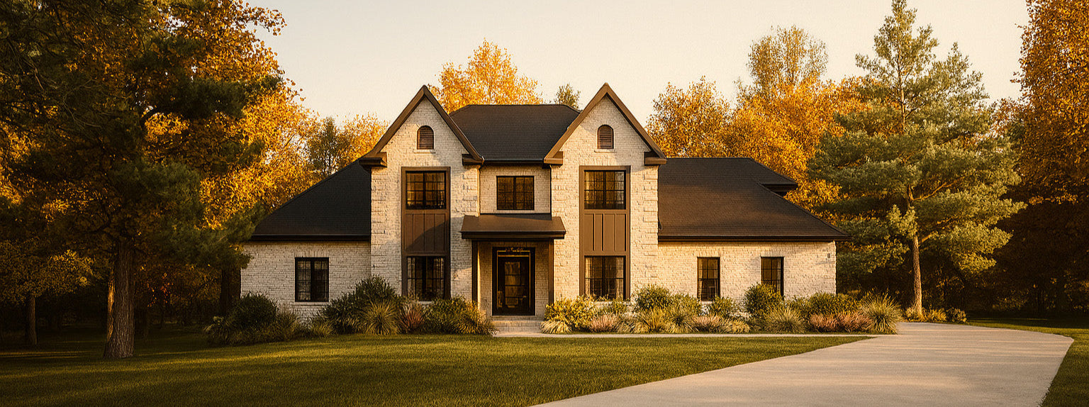 Cream stone and brown finish custom home  that Paragon designed set against autumn trees - two story house with black pain windows.